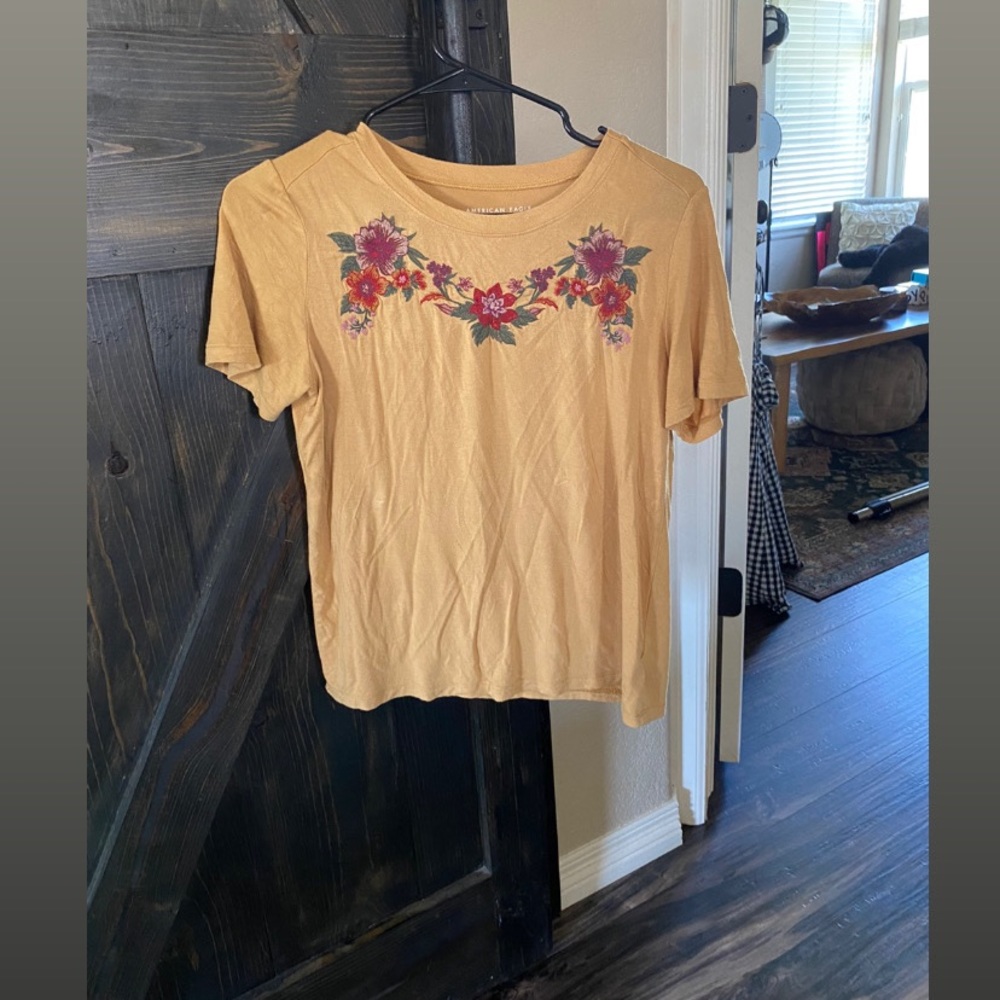 This is a mustard yellow color T-shirt, Size Small